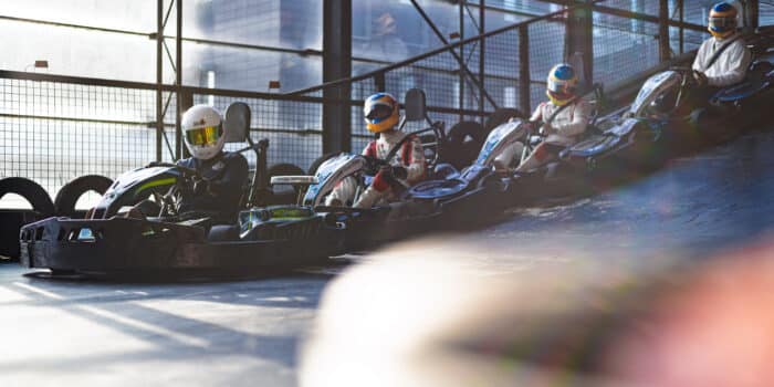 Drivers racing on the go-kart track at Race Planet Delft